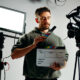 Camera man holding clapperboard - Gifts for Filmmakers